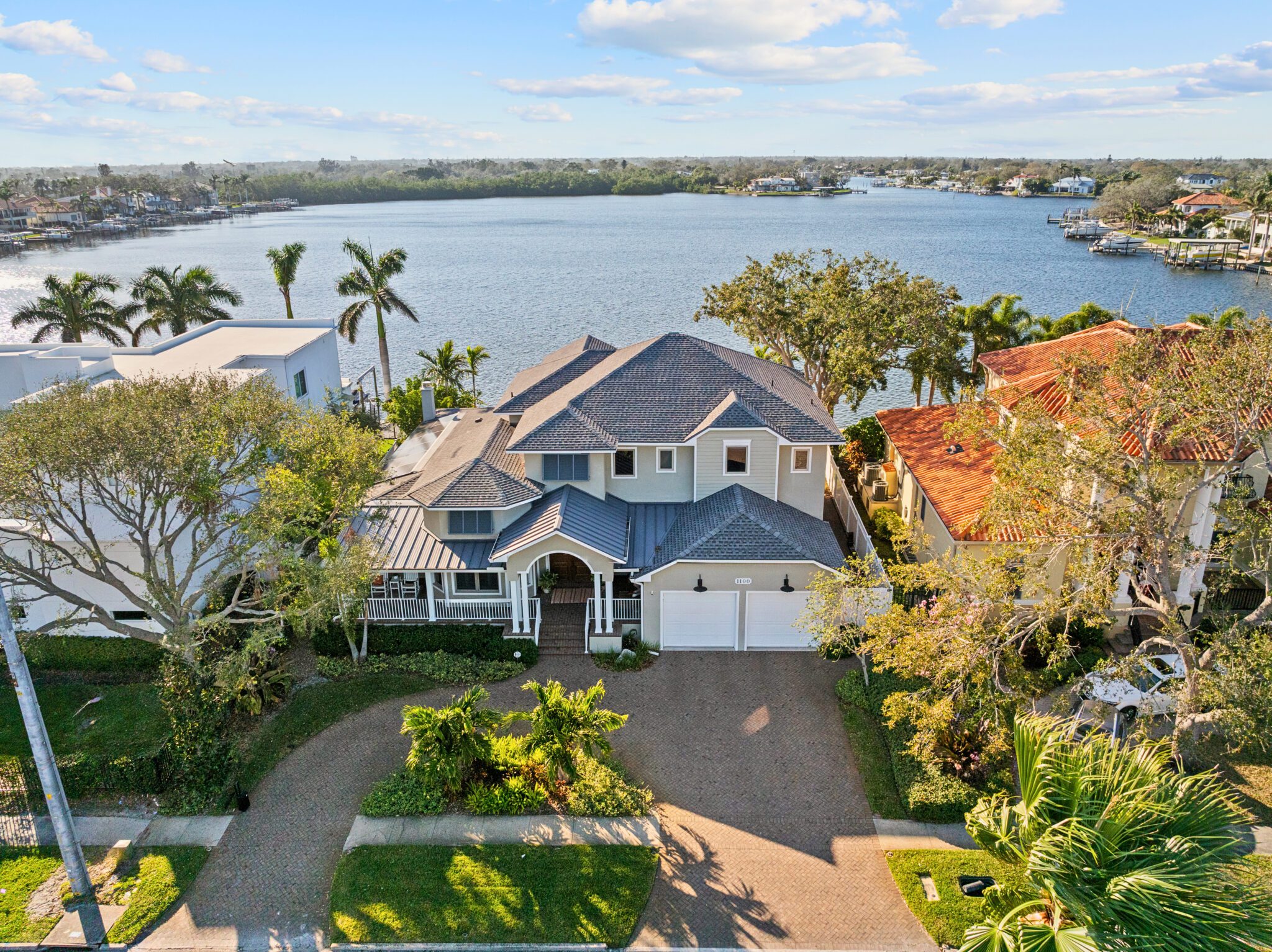 Aerial view of 1100 Cordova Blvd NE, a luxury waterfront home in Snell Isle, St. Petersburg, featuring a resort-style pool, deep-water dock, and stunning bayou views.